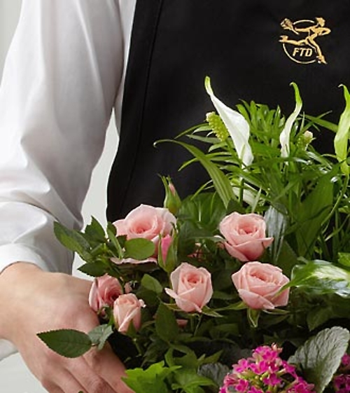 The Florist Designed Blooming and Green Plants in a Basket